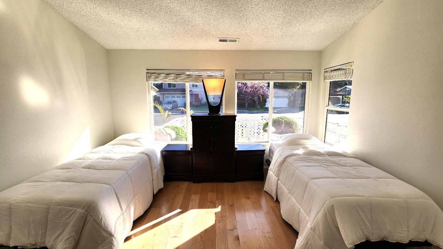 Bright resident bedroom with two twin beds dressed in white bedding