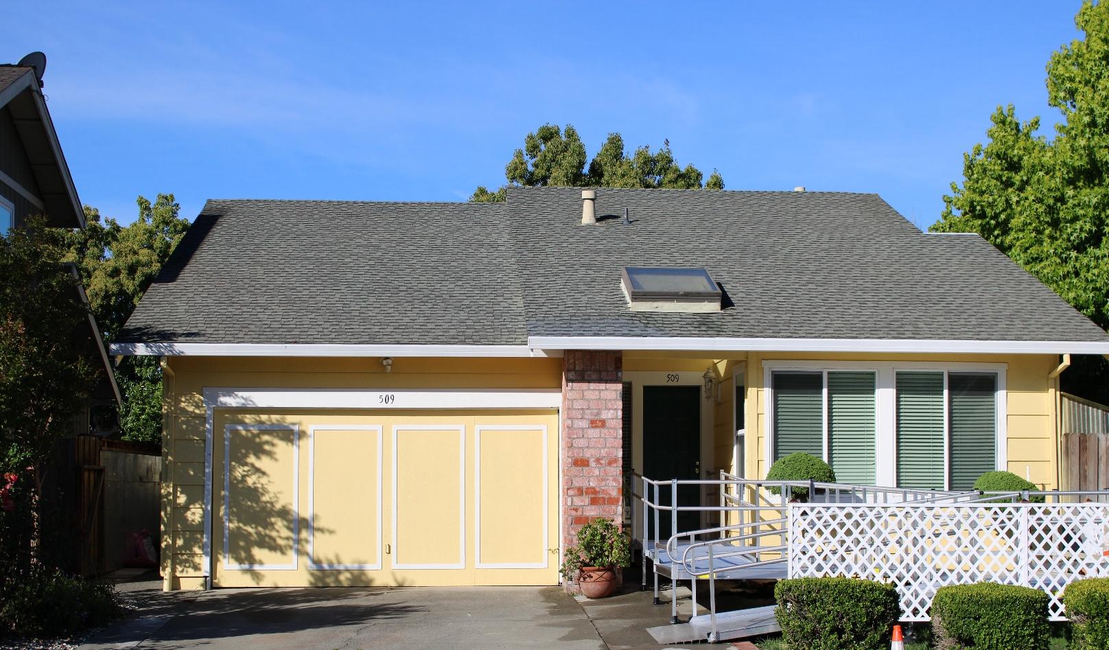 Front of the Holistic Home Care residence with a wheelchair ramp and landscaped entry